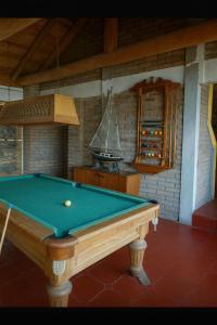 a pool table in a room with a boat on the wall at Beachfront house for 20 people in Vichuquén Lake