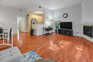 a living room with a hard wood floor and a tv at Urban retreat- Quiet comfy 1 bedroom condo near LAX in Los Angeles