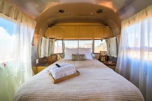 a bedroom with a large bed in an rv at The Outpost Grand Canyon in Williams