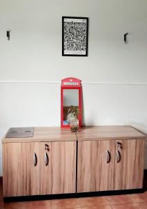 a wooden cabinet with a mirror on top of it at Kariri Hostel in Crato