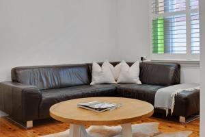 Una sala de estar con un sofá de cuero y una mesa de café. en Peter Cottage - CBD Location Bright & Homely, en Wagga Wagga 19 fotos más