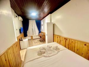 En eller flere senge i et værelse på Taksim Vista Apart