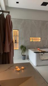 a bathroom with a sink and lights on the wall at استديو ميرا in Abha