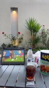 a table with a tablet computer sitting on top of it at استديو ميرا in Abha