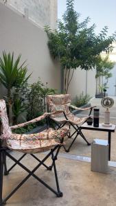 a pair of chairs sitting on a patio at استديو ميرا in Abha