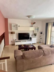 a living room with a couch and a table at Gurugu Beach House in Palm-Mar +21 photos