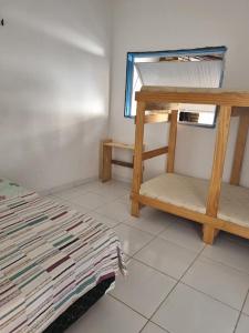 a room with a bunk bed and a window at Casa Petit Canoa Quebrada in Aracati