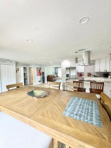 a kitchen and living room with a large wooden table at Modern cozy Home Palm Coast in Palm Coast