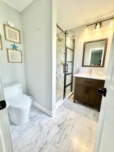 a bathroom with a toilet and a sink at Modern cozy Home Palm Coast in Palm Coast
