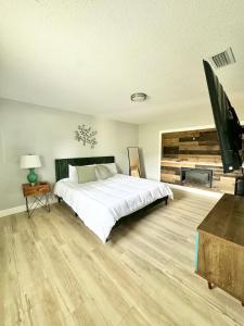 a bedroom with a large bed and a flat screen tv at Modern cozy Home Palm Coast in Palm Coast