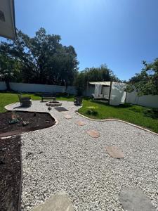 a patio with rocks and a yard with trees at Modern cozy Home Palm Coast in Palm Coast