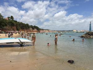 a group of people in the water at a beach at CostaSol Pipa Chalés in Pipa
