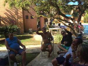 a group of people sitting in chairs in a yard at CostaSol Pipa Chalés in Pipa