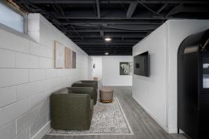 a room with couches and a tv and a wall at Main Street Retreat Hot Tub Sleeps 8 in Plymouth