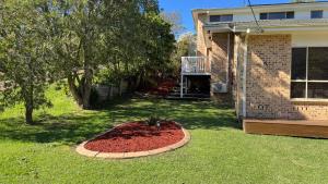 a garden in the yard of a house at Palacete Beach Resort - entire home in Culburra Beach