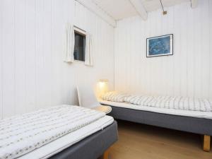 a bedroom with two beds and a window at 12 person holiday home in Fanø-By Traum in Fanø