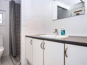 a white bathroom with a sink and a shower at 12 person holiday home in Fanø-By Traum in Fanø +31 photos
