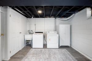 a laundry room with two refrigerators and a sink at Main Street Retreat Hot Tub Sleeps 8 in Plymouth +43 photos