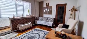 a living room with a couch and a table at Magic Craiova Stay in Craiova