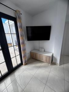 a living room with a flat screen tv on the wall at Villa Stefi in Playa Blanca