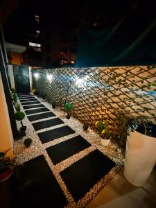 a walkway with potted plants and a brick wall at Pri Home in Pristina