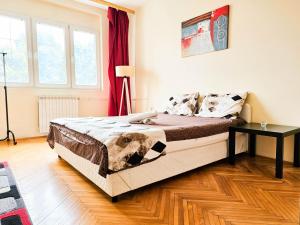 a bedroom with a bed and a table in it at Mother Teresa Apartments in Skopje +42 photos