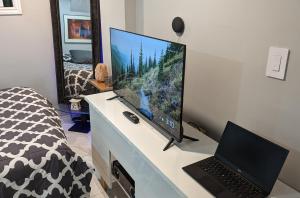a computer monitor on a desk with a laptop at Chic Japanese Vibe Smart Home- Liberty Village 10 min walk to CNE & GO Station in Toronto