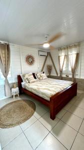 a bedroom with a large bed in a room at MAJO LOUNGE dans un jardin tropical à 5 min de la mer Caraïbe in Saint-Pierre +33 photos