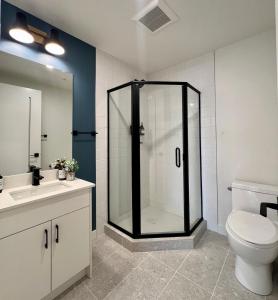 a bathroom with a shower with a toilet and a sink at Luxury 2 Bedroom Mountain View Condo in Canmore +44 photos