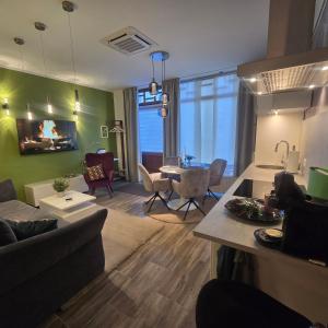 a living room with a couch and a table at City APART - FeWo Klimaanlage Whirpool Panoramafenster 5 Personen Kulturdenkmal Dessau-Roßlau in Dessau