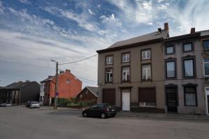 a black car parked in front of a building at Charleroi Airport House 3 chambres & Parking in Charleroi