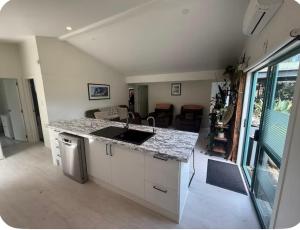 a kitchen with a sink and a counter top at Whangapoua retreat in Whangapoua