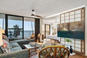 a living room with a view of the ocean at Lauloa 303 in Wailuku