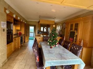 a kitchen with a table with a christmas tree on it at Stud House in Private Country Estate near Bruton in Gillingham