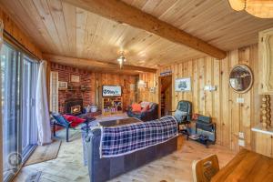a living room with wood paneling and a fireplace at Pet-Friendly Original Ski Cabin by StayIn in Panorama
