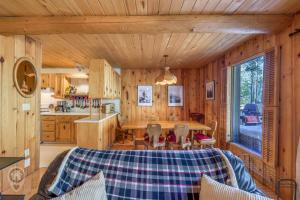 a kitchen and dining room with a table in a cabin at Pet-Friendly Original Ski Cabin by StayIn in Panorama