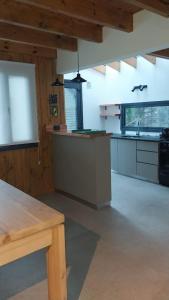 a large kitchen with a counter top in a room at Cabaña martita in San Martín de los Andes +11 photos