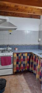 a kitchen with a stove and a counter top at Las Rosas EH in El Hoyo