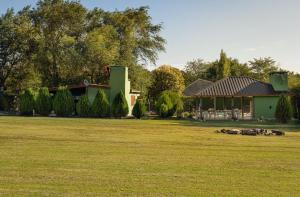 a house with a yard with sheep in front of it at Tierras de Breena in Los Reartes +7 photos