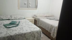 En eller flere senge i et værelse på Pousada Maria