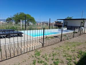 a fence in front of a swimming pool at The Herman House in Cerrillos