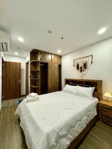 Giường trong phòng chung tại Happy One Central Bình Dương +2 ảnh