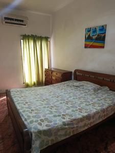 a bedroom with a large bed and a window at Casa a 10 minutos de la playa y 15 del aeropuerto in Catia La Mar
