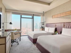 a hotel room with two beds and a desk and a window at Fairmont Quasar Istanbul Hotel in Istanbul +212 photos