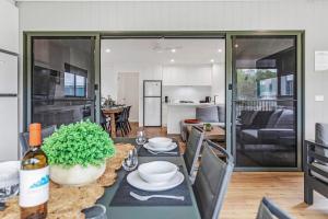 a kitchen and living room with a table with a table sidx sidx sidx at #15 Highview in Moama +16 photos