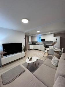 a living room with a couch and a table at Kirkevegen apartment in Brumunddalen