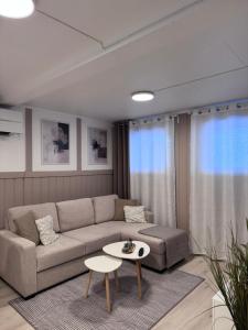 a living room with a couch and a table at Kirkevegen apartment in Brumunddalen