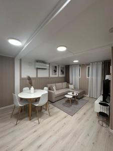 a living room with a couch and a table at Kirkevegen apartment in Brumunddalen