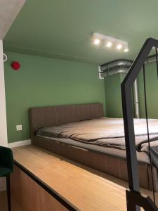 a bunk bed in a room with green walls at Sleep & Fly & Stay Comfort Apartament I in Wrocław