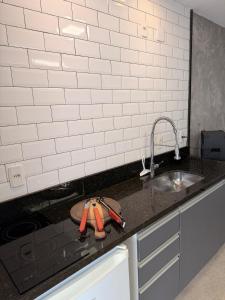 a kitchen counter top with a sink and a sink at Refúgio de luxo in Pedra de Guaratiba +45 photos